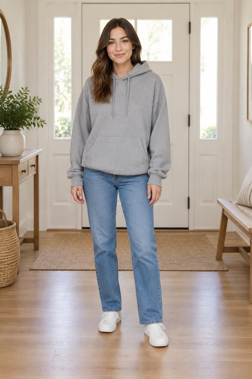 Grey oversized hoodie with straight-leg jeans and clean low-top sneakers.